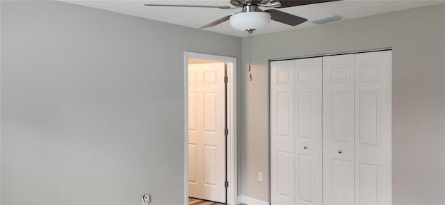 unfurnished bedroom with ceiling fan, a closet, and visible vents