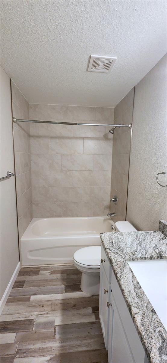 full bathroom with visible vents, vanity, toilet, and wood finished floors