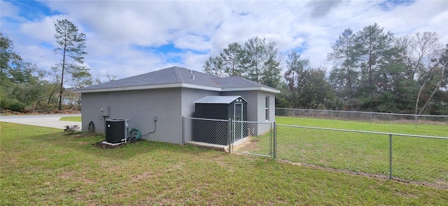 view of property exterior featuring fence, cooling unit, a lawn, and stucco siding