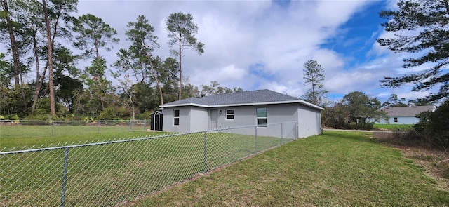 back of property with a lawn, a fenced backyard, and stucco siding