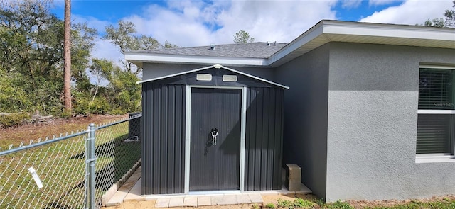 view of shed with fence