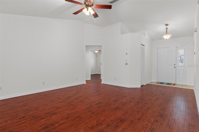 unfurnished living room featuring lofted ceiling, dark wood-style flooring, a ceiling fan, and baseboards