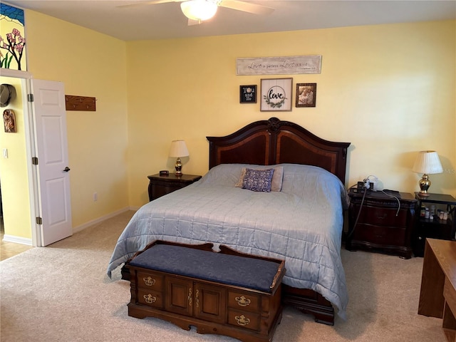 bedroom with a ceiling fan, light colored carpet, and baseboards