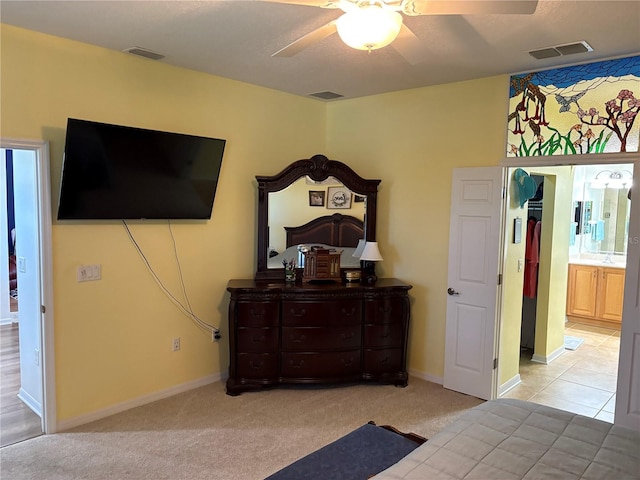 bedroom with visible vents, a ceiling fan, and light colored carpet