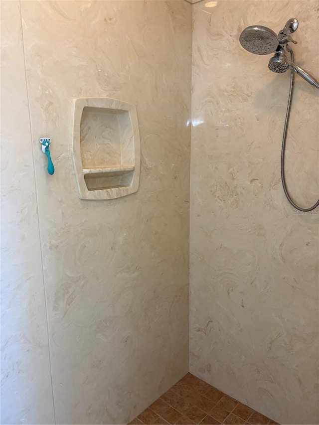 bathroom with a tile shower