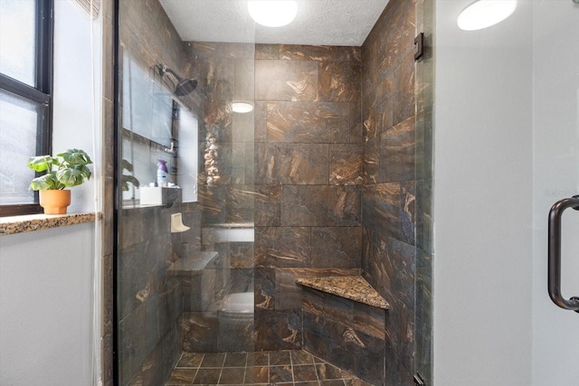 full bath with a shower stall and a textured ceiling