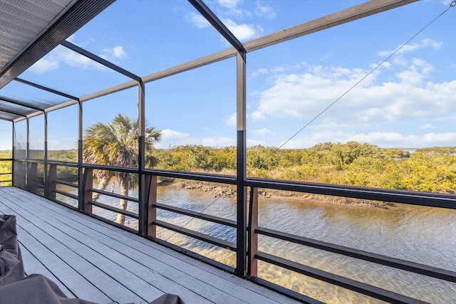 wooden terrace with a water view and a view of trees