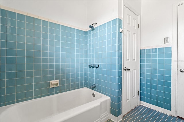 bathroom with wainscoting, tile walls, and shower / bathtub combination