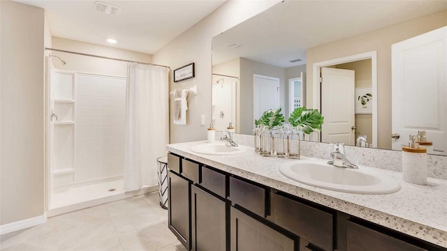 full bathroom featuring tile patterned floors, a sink, and a shower stall