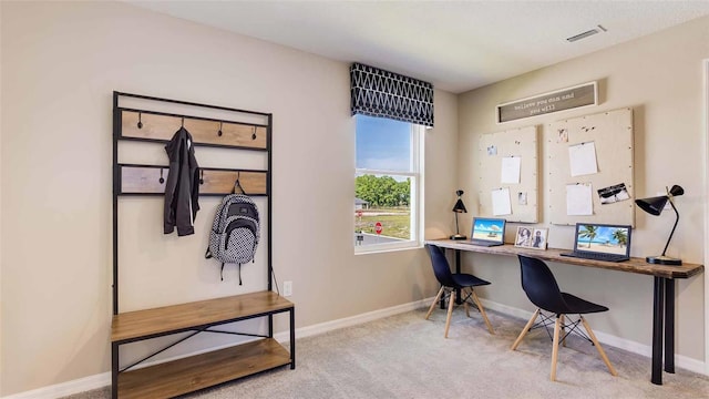 home office with light carpet, baseboards, and visible vents