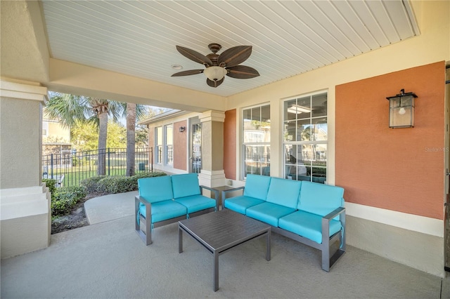 view of patio with fence, an outdoor hangout area, and a ceiling fan