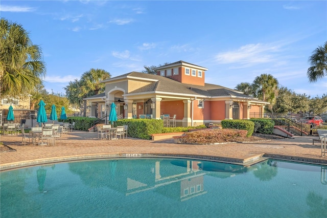 pool featuring a patio area and fence