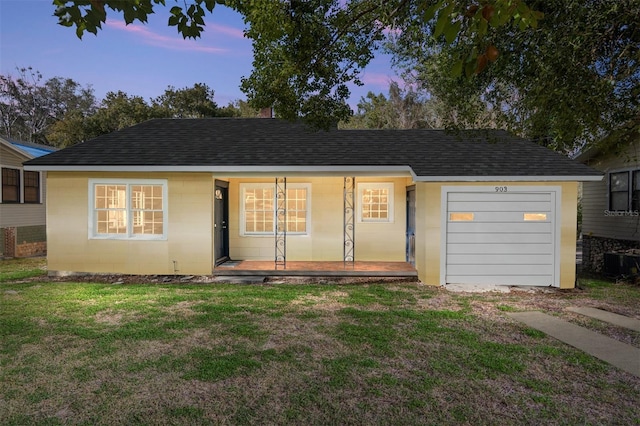 view of front of property featuring a yard, a porch, a shingled roof, and concrete block siding