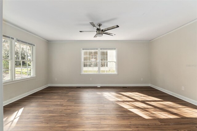 empty room featuring a ceiling fan, baseboards, ornamental molding, and dark wood-type flooring