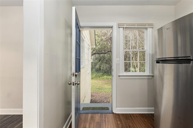 entryway featuring baseboards and dark wood finished floors