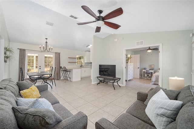 living room with lofted ceiling, light tile patterned floors, visible vents, and french doors