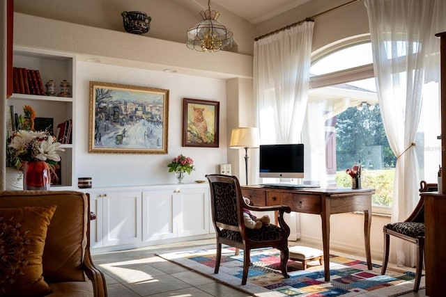 tiled home office featuring a healthy amount of sunlight and an inviting chandelier