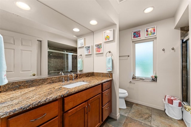 bathroom with a stall shower, baseboards, toilet, vanity, and recessed lighting