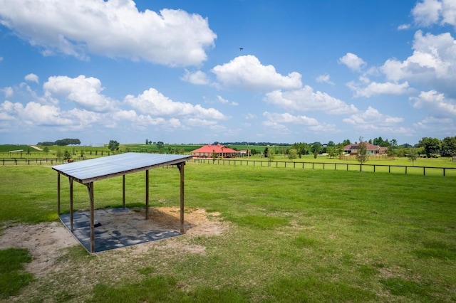 view of yard featuring a rural view and fence