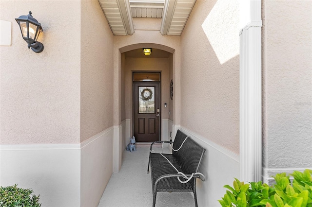 entrance to property featuring stucco siding