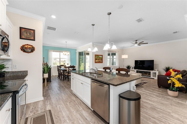 kitchen featuring appliances with stainless steel finishes, light wood-style floors, visible vents, and a sink