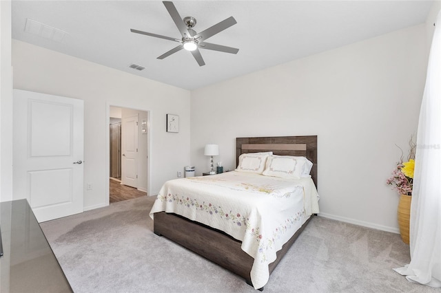 bedroom with carpet, visible vents, and baseboards