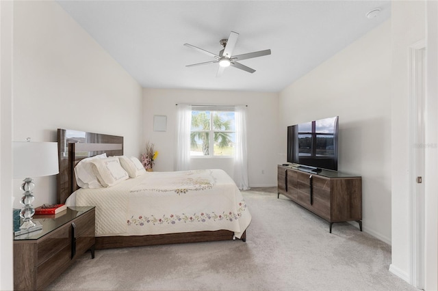 bedroom with ceiling fan, baseboards, and light colored carpet