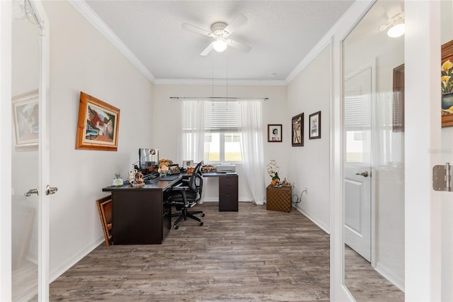 office featuring crown molding, baseboards, ceiling fan, and wood finished floors