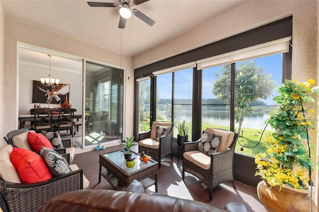 sunroom featuring a water view, a wealth of natural light, and ceiling fan with notable chandelier