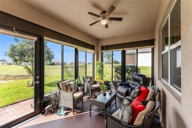 sunroom / solarium with a ceiling fan