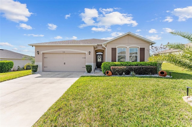 view of front of home with driveway, a front yard, and stucco siding