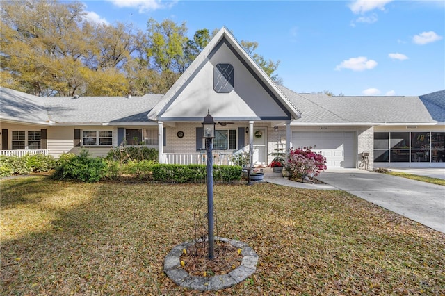 view of front of house with brick siding, concrete driveway, a front yard, covered porch, and a garage