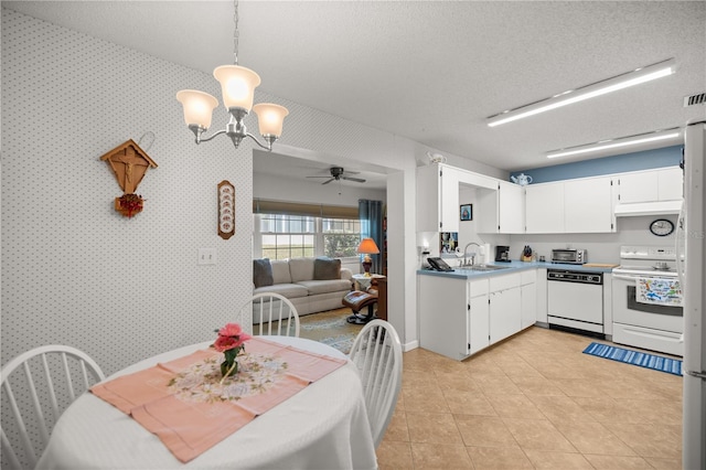 kitchen featuring wallpapered walls, ceiling fan with notable chandelier, white cabinets, white appliances, and a textured ceiling