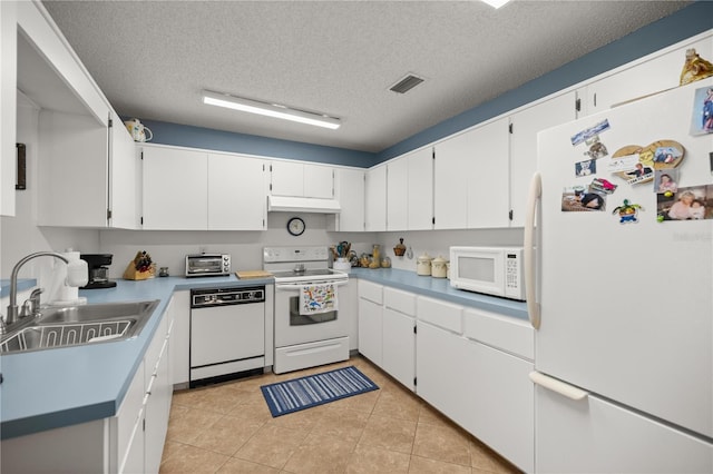 kitchen with visible vents, a sink, under cabinet range hood, white appliances, and white cabinets