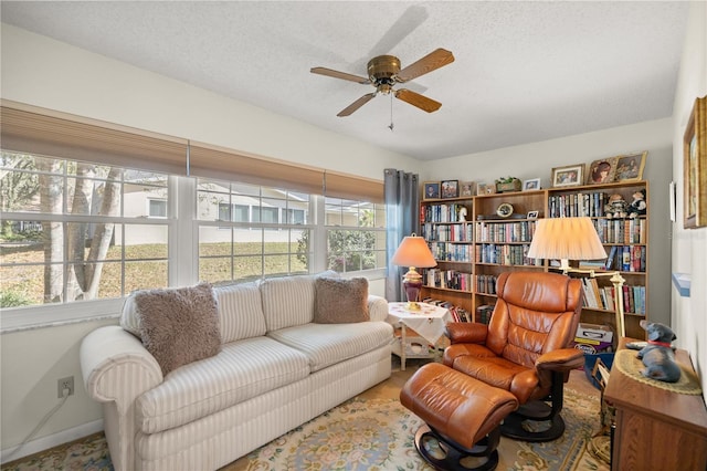 sitting room featuring a textured ceiling and a ceiling fan