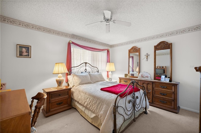 bedroom featuring baseboards, a textured ceiling, carpet, and a ceiling fan