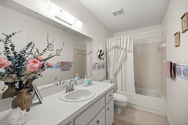 bathroom featuring visible vents, toilet, vanity, a textured ceiling, and shower / bathtub combination with curtain