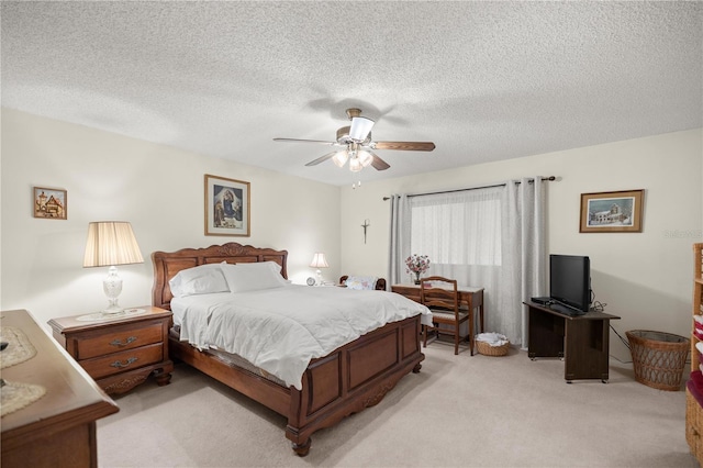 bedroom featuring light colored carpet, a textured ceiling, and ceiling fan