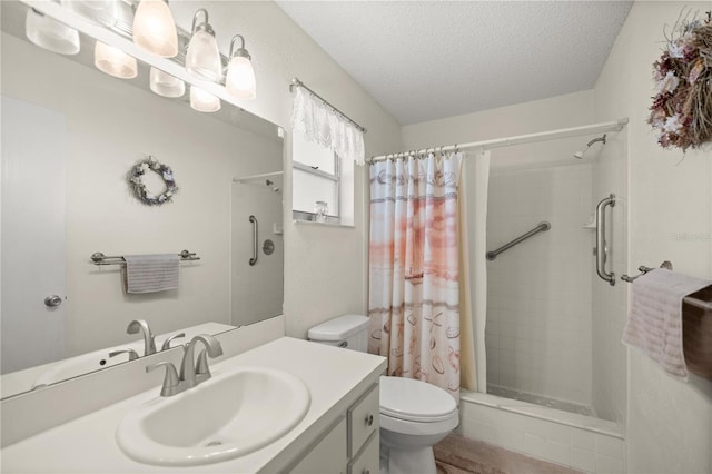 full bathroom featuring a tile shower, a textured ceiling, toilet, and vanity