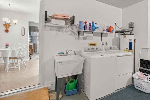 laundry room with laundry area, a textured ceiling, a notable chandelier, independent washer and dryer, and electric water heater