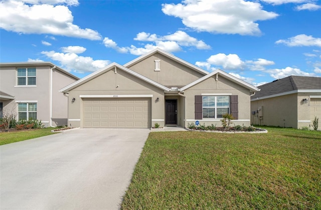 ranch-style house with a garage, a front lawn, concrete driveway, and stucco siding