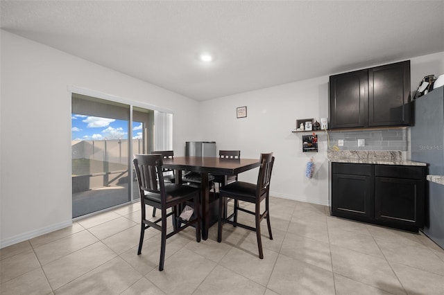 dining area featuring light tile patterned flooring and baseboards