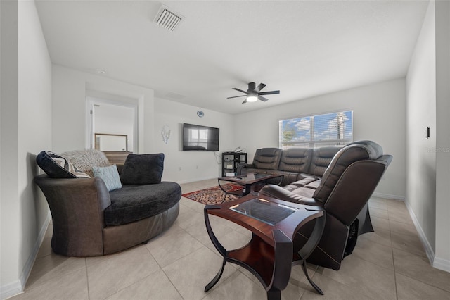 living room with light tile patterned floors, ceiling fan, visible vents, and baseboards