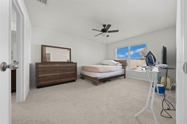 bedroom featuring light carpet and a ceiling fan