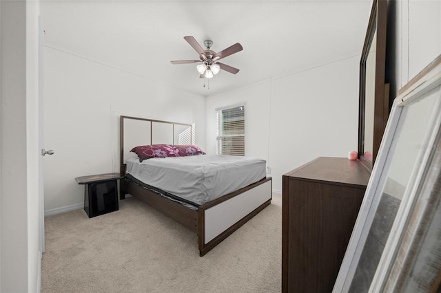 bedroom with light carpet and a ceiling fan