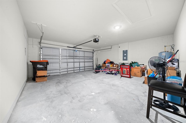 garage featuring a garage door opener, concrete block wall, and electric panel