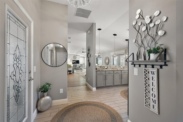 entrance foyer featuring wood tiled floor, visible vents, and baseboards