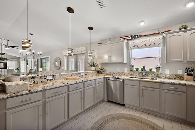 kitchen featuring visible vents, dishwasher, gray cabinetry, pendant lighting, and a sink