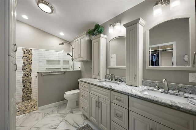 bathroom featuring marble finish floor, walk in shower, and a sink