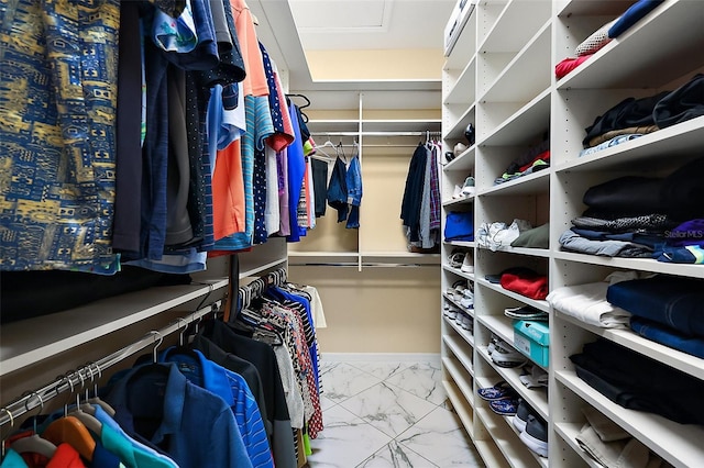 spacious closet with marble finish floor